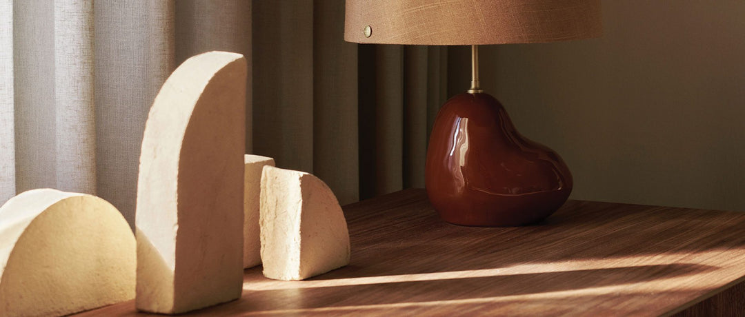 Ferm LIVING Sculptures from their AW22 collection on a table next to a lamp