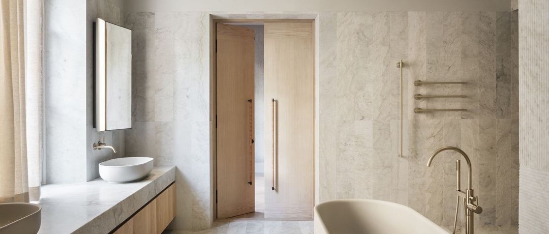 Interior bathroom photo of the Habitat 100 project. it features a very simple, but luxurious bathroom with highly elevated details of metallics, leathers, and stone.