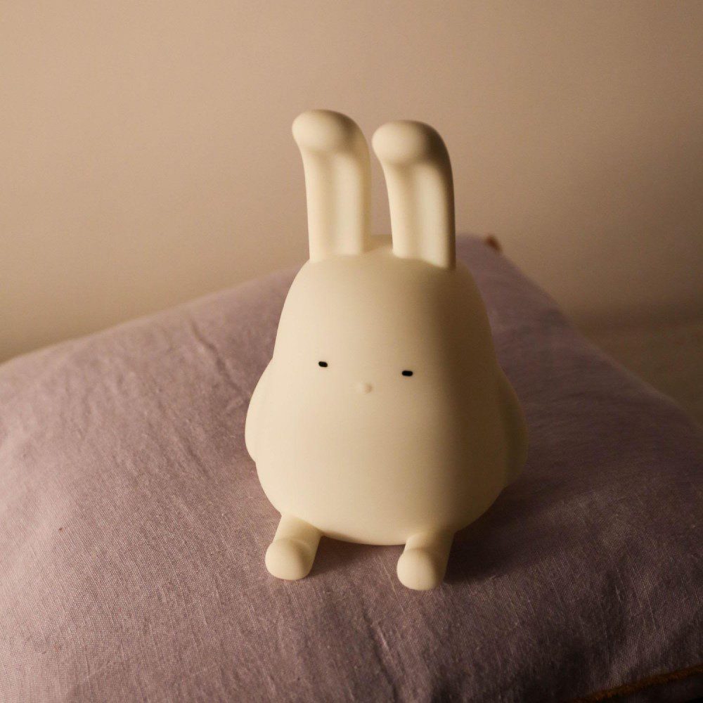 Natural lighting, perspective view of a kids' lamp in the shape of a rabbit.