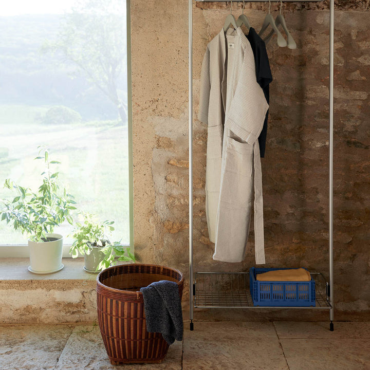 Colour crate storage box in electric blue on a coat rack.