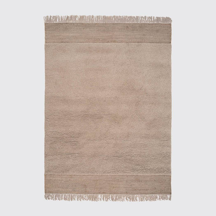 A packshot of hand-knotted rug in beige by Linie Design.