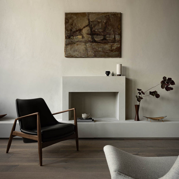 The image features the Seal lounge chair with black leather in a Scandi style apartment.