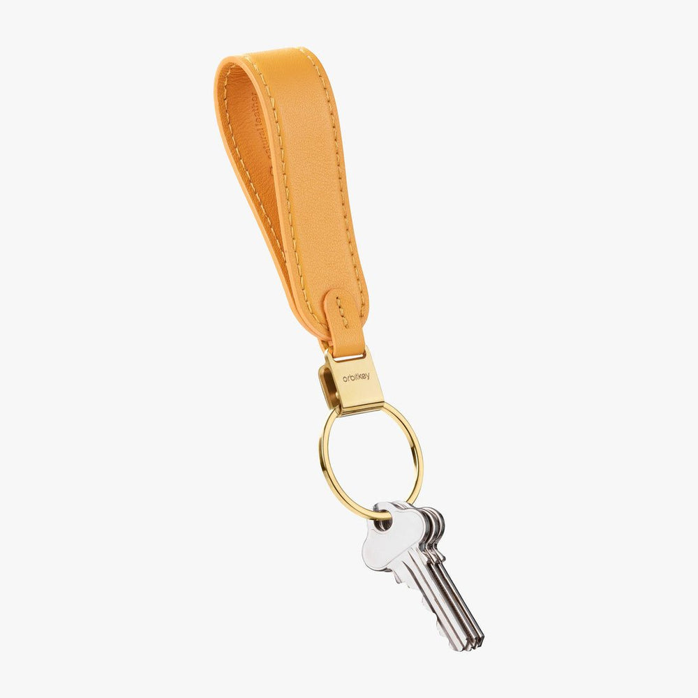 A packshot of Loop keychain in orange with a quick-snap lock system.