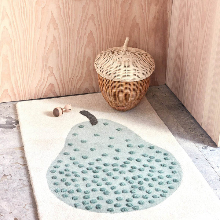 Pear tufted rug in kids room and a rattan basket on it.