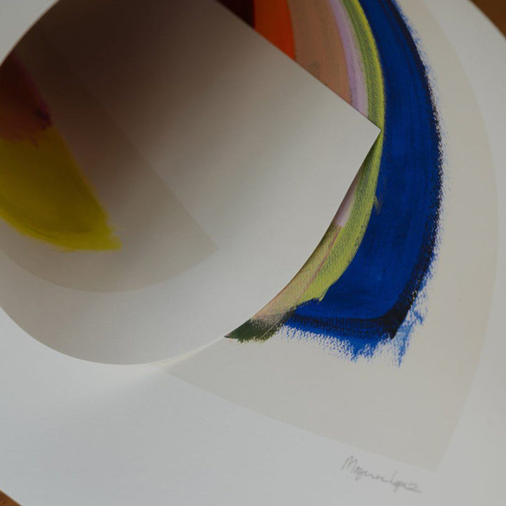 Natural lighting, close up view of an art print's detail with the artist's signature.