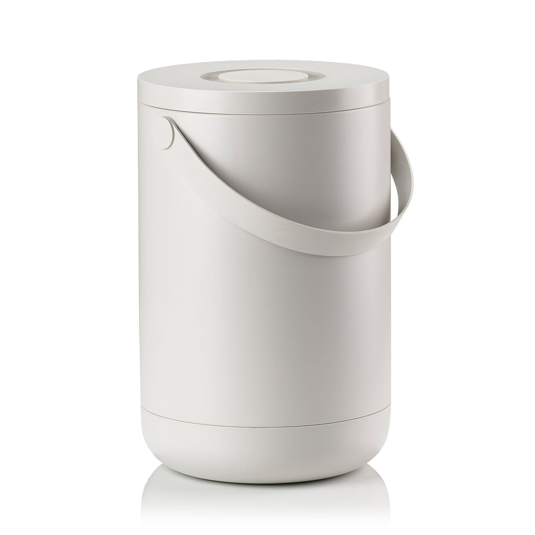 White background, perspective view studio image of a tall, grey, cylindrical trash bin with a pail-type handle.